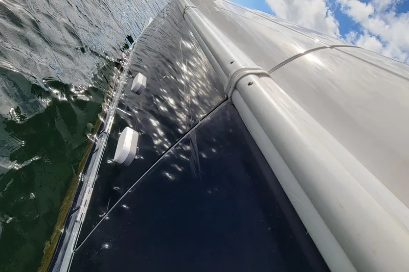 Slide: The Image of Close-up of 2016 Intrepid 327 Cuddy boat on water, reflecting sunlight. - 6