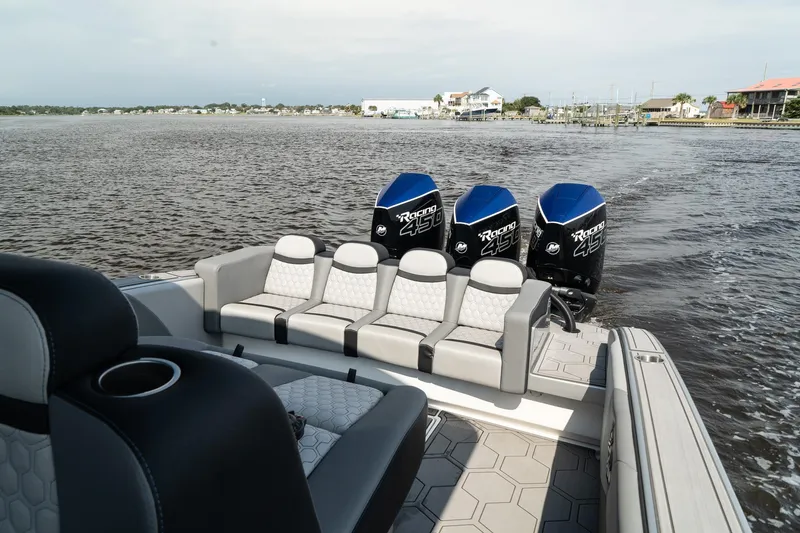 Slide: The Image of 2023 Statement 380 Open boat with triple engines on the water. - 10