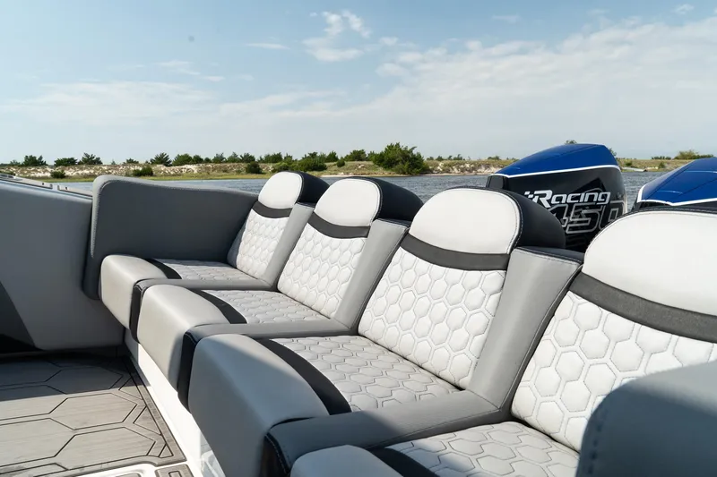 Slide: The Image of 2023 Statement 380 Open boat with triple engines cruising on water. - 11