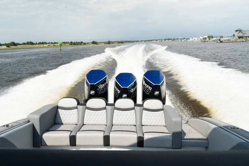 Slide: The Image of 2023 Statement 380 Open boat on water, featuring triple engines. - 12