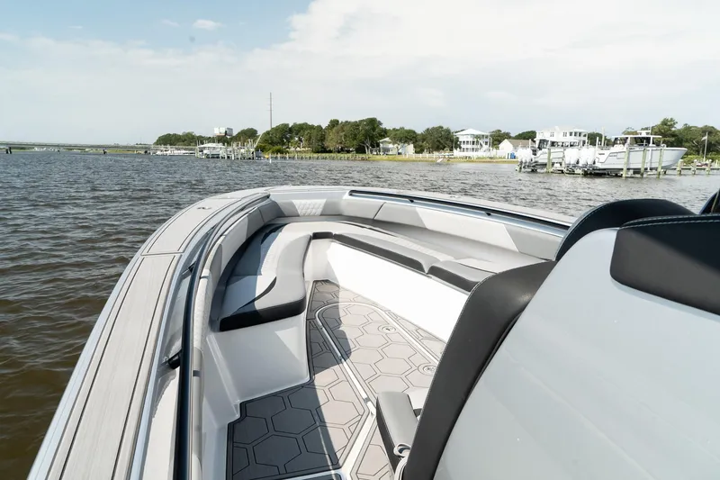 Slide: The Image of 2023 Statement 380 Open boat on calm water near shoreline houses. - 14