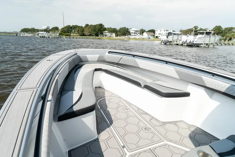 Slide: The Image of 2023 Statement 380 Open boat cruising on a calm waterway near coastal homes. - 15
