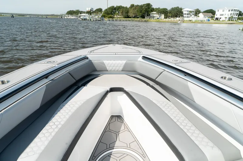 Slide: The Image of 2023 Statement 380 Open boat with triple outboard engines on a calm waterway. - 16