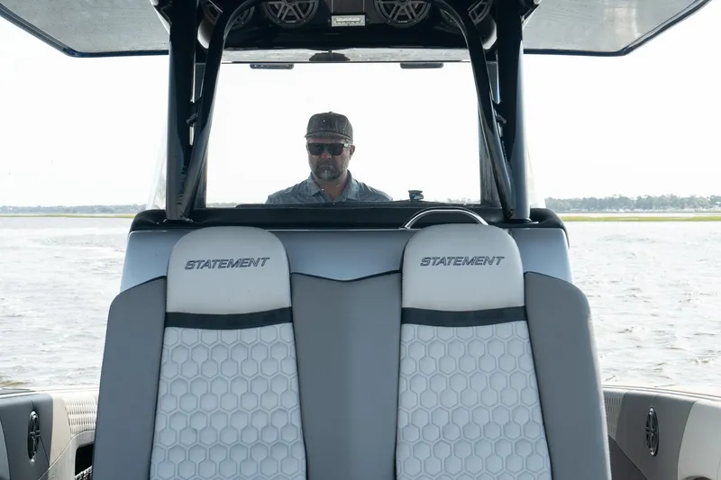 Slide: The Image of 2023 Statement 380 Open boat with triple engines cruising on open water. - 18