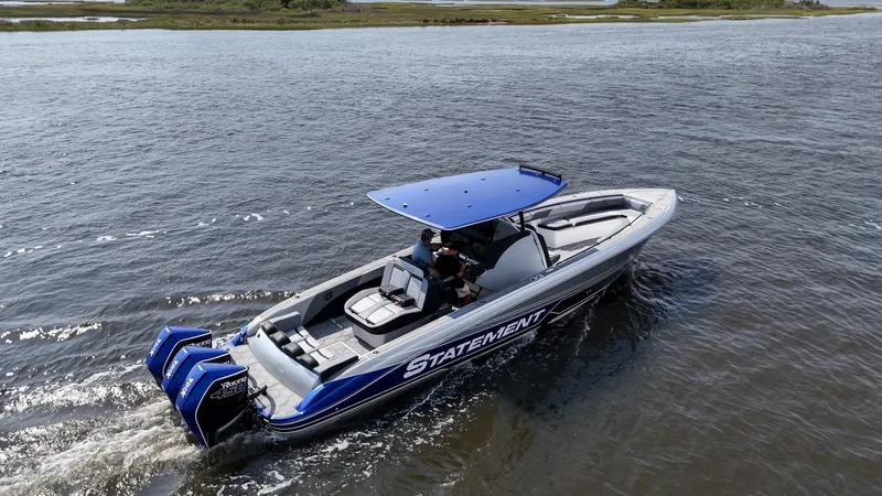 Slide: The Image of 2023 Statement 380 Open boat cruising on open water, featuring dual engines and sleek design. - 27