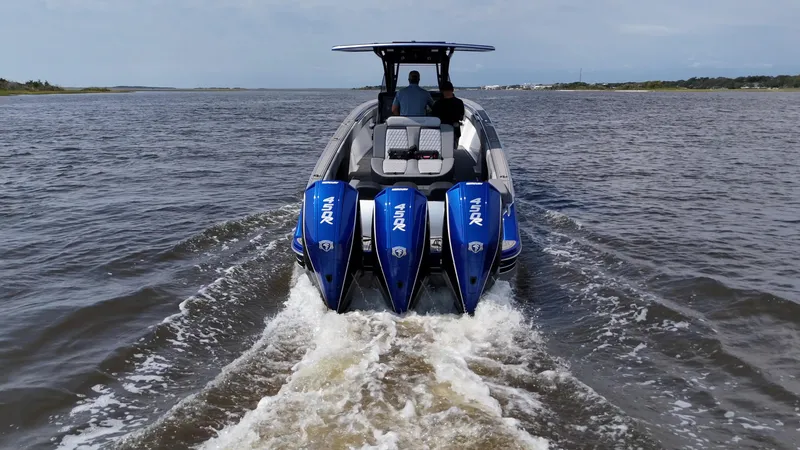 Slide: The Image of 2023 Statement 380 Open boat cruising on open water, rear view. - 28