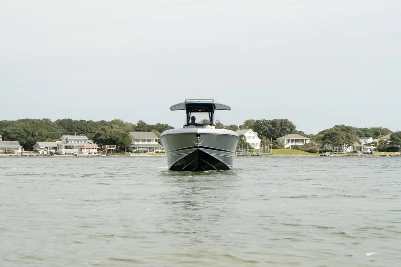 Slide: The Image of 2023 Statement 380 Open boat cruising near sandy shoreline. - 8