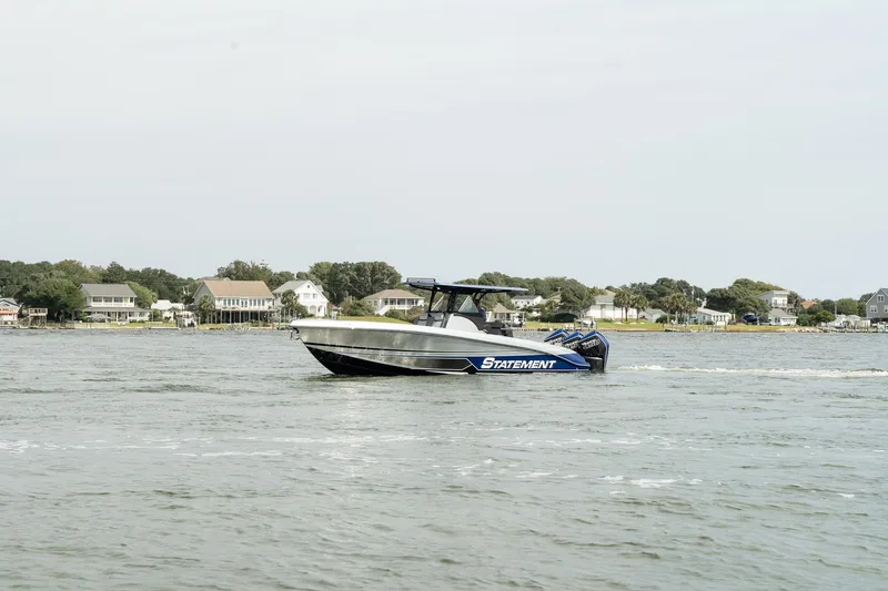 Slide: The Image of 2023 Statement 380 Open boat cruising on calm waters. - 9