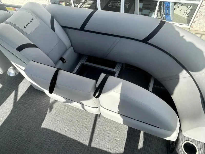 Slide: The Image of 2024 Crest Classic LX 220 SLC boat interior with gray seating and cup holders. - 11