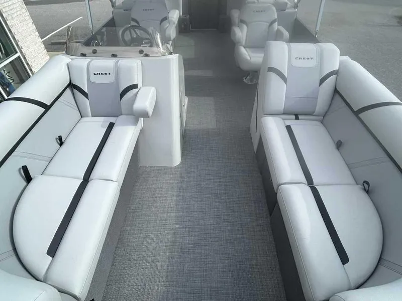 Slide: The Image of 2024 Crest Classic LX 220 SLC boat interior with plush seating and modern design. - 3