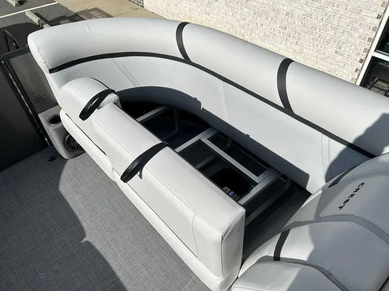 Slide: The Image of 2024 Crest Classic LX 220 SLC boat interior with open storage compartment. - 6