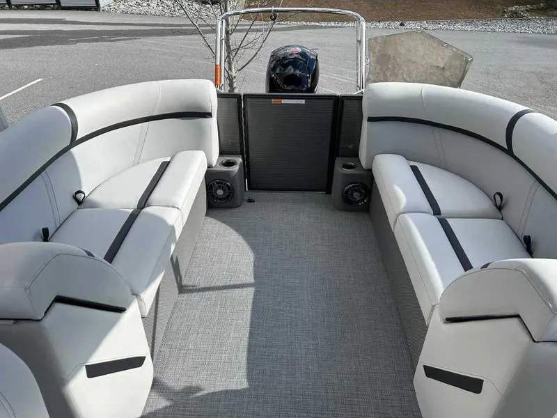 Slide: The Image of 2024 Crest Classic LX 220 SLC pontoon boat interior with plush seating and speakers. - 9