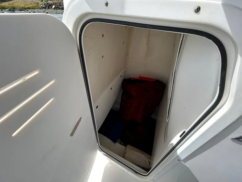 Slide: The Image of Storage compartment of 2021 NauticStar 2102 Legacy boat, open door view. - 3
