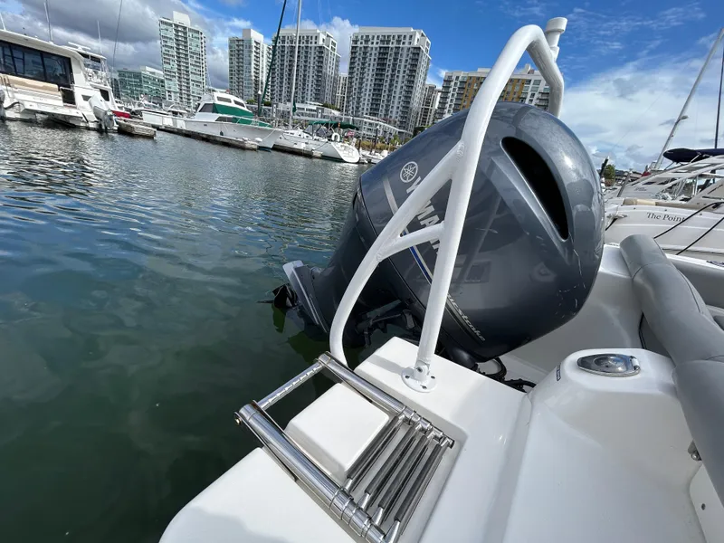 Slide: The Image of NauticStar 2102 Legacy boat with outboard motor docked in marina, 2021 model. - 5