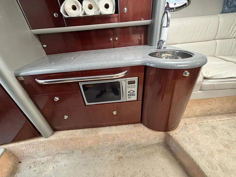 Slide: The Image of 2006 Formula 400 Super Sport yacht interior with kitchenette, featuring microwave and sink. - 15