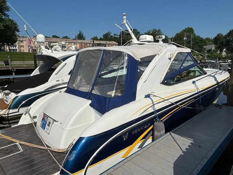 Slide: The Image of 2006 Formula 400 Super Sport boat docked at marina, featuring sleek design and blue accents. - 2