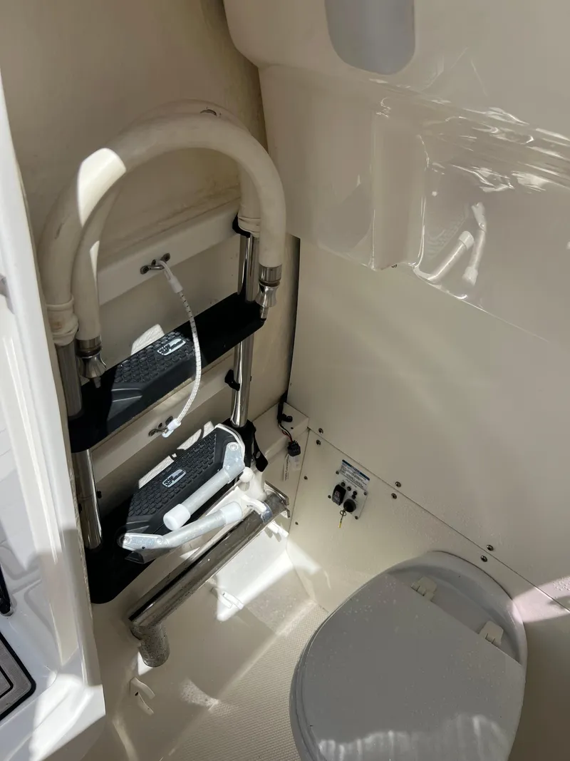 Slide: The Image of 2021 Robalo R272 Center Console interior with ladder and toilet. - 19