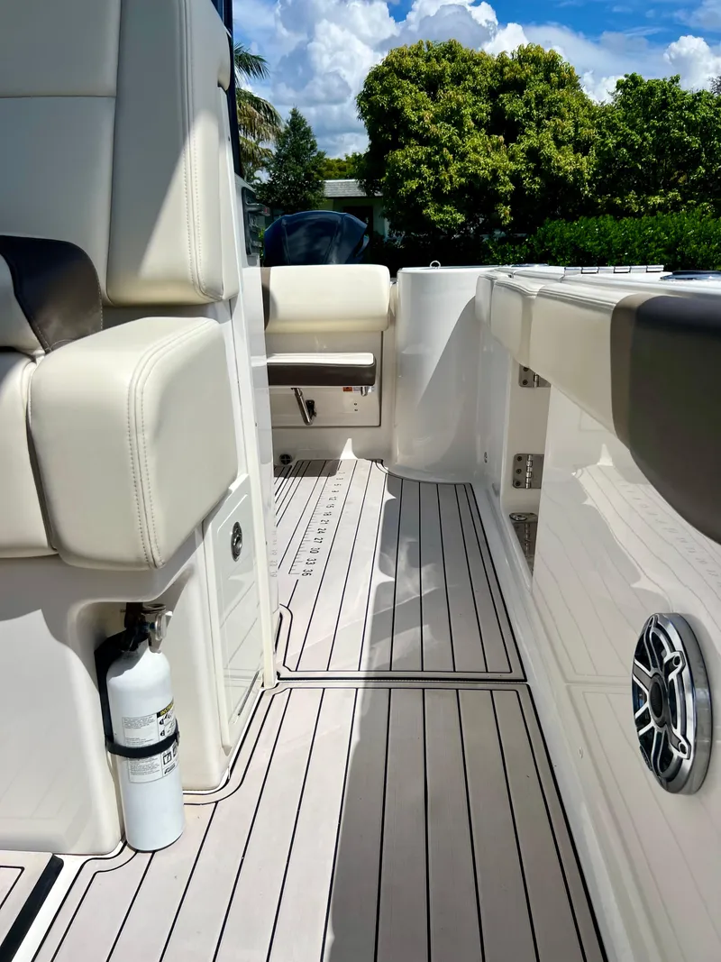 Slide: The Image of 2021 Robalo R272 Center Console boat interior with cushioned seating and sleek flooring. - 25