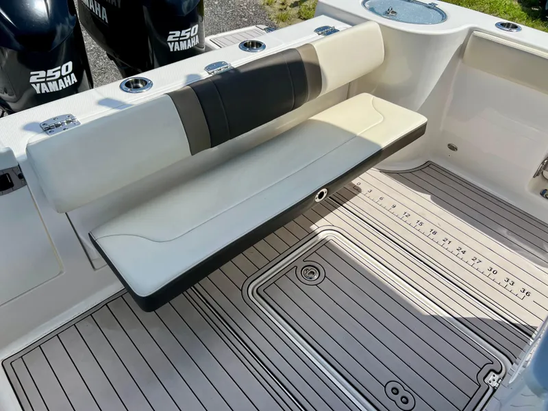 Slide: The Image of 2021 Robalo R272 Center Console boat with Yamaha 250 engines, featuring a foldable bench seat. - 29