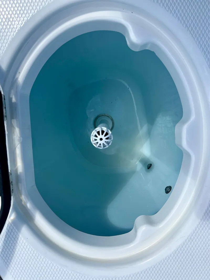 Slide: The Image of Livewell on 2021 Robalo R272 Center Console boat, filled with water. - 31