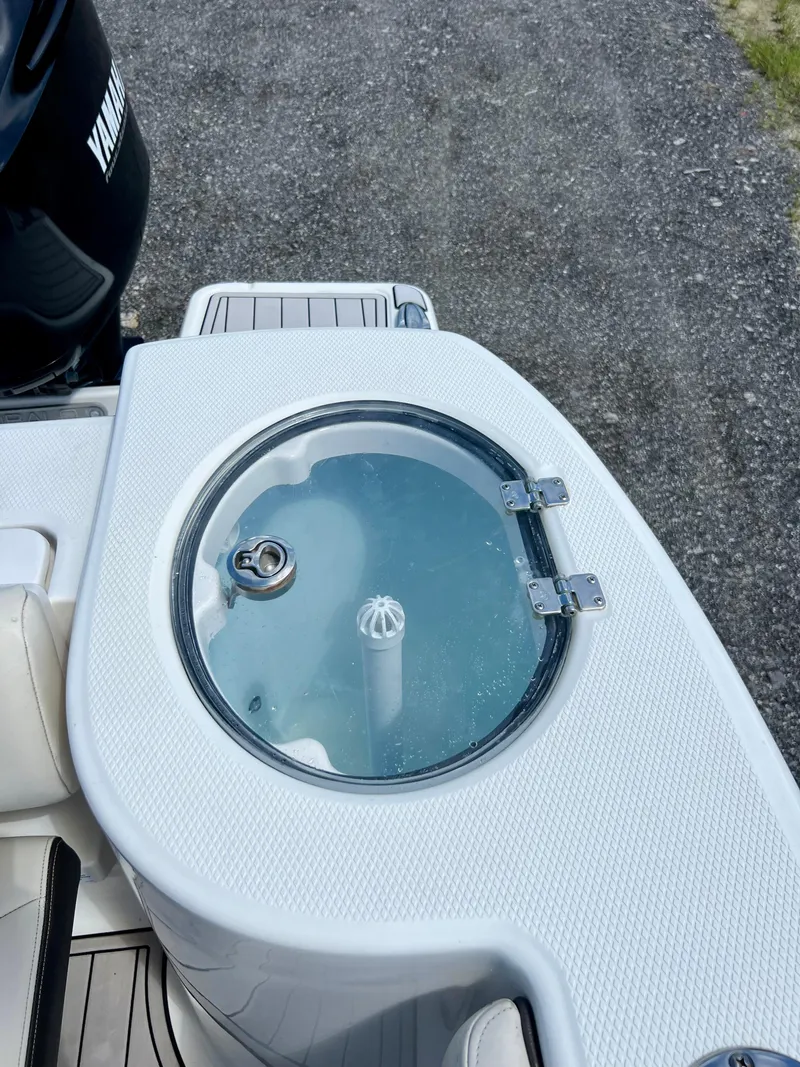 Slide: The Image of 2021 Robalo R272 Center Console livewell with clear lid and latch. - 32
