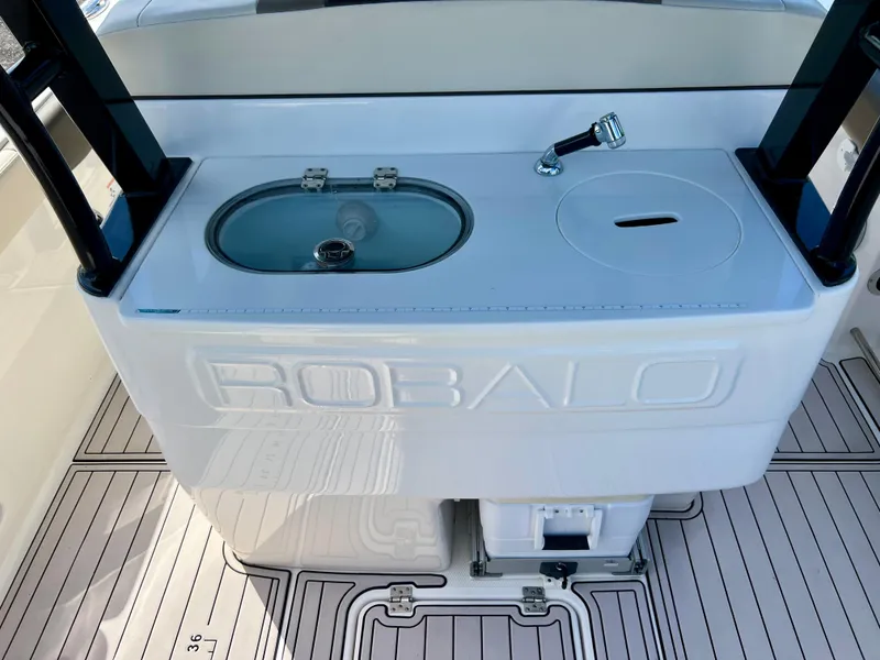 Slide: The Image of 2021 Robalo R272 Center Console boat with sink and storage area. - 35