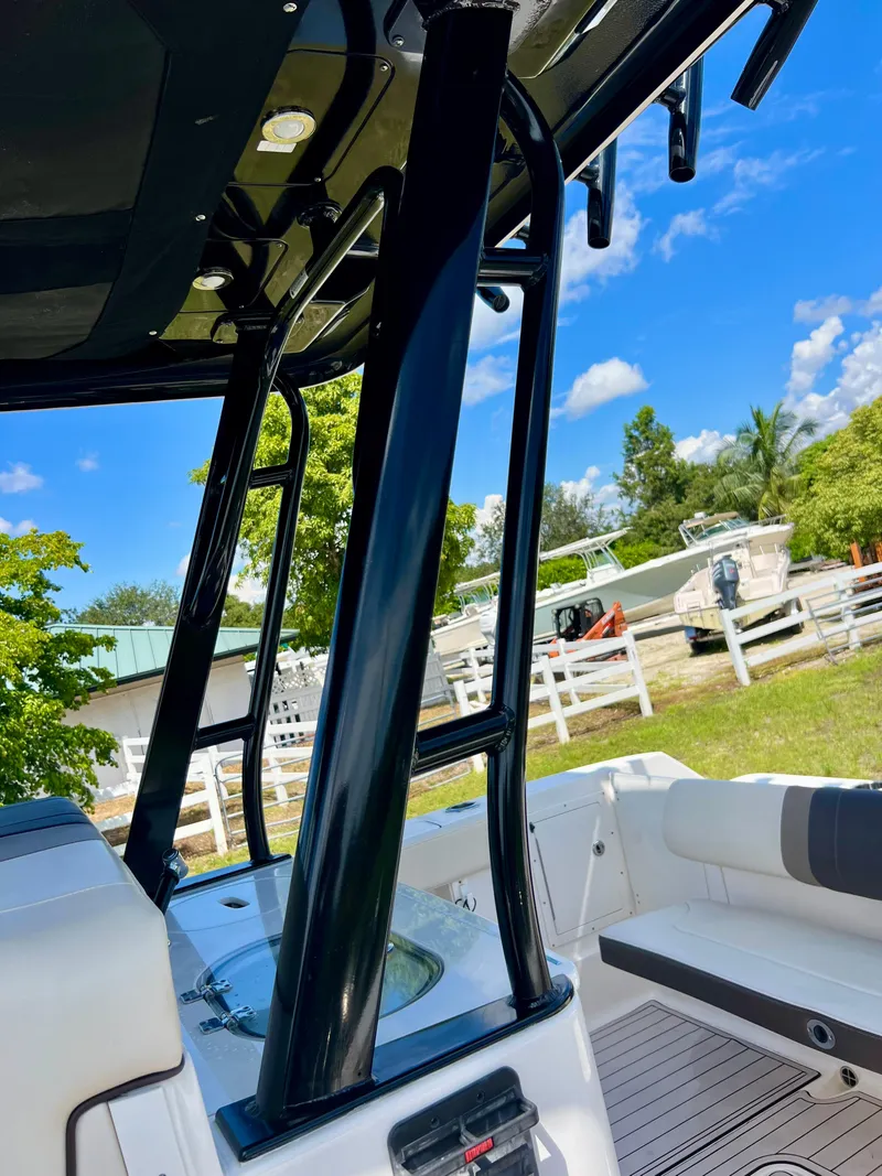 Slide: The Image of 2021 Robalo R272 Center Console boat, sleek design, sunny outdoor setting. - 36