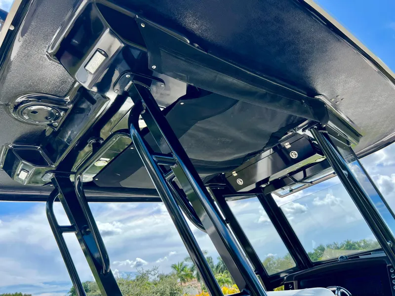 Slide: The Image of 2021 Robalo R272 Center Console T-top with blue sky background. - 38