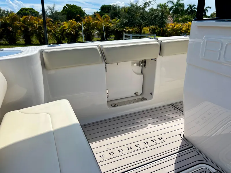 Slide: The Image of 2021 Robalo R272 Center Console boat interior with seating and deck ruler. - 42