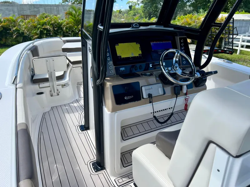 Slide: The Image of 2021 Robalo R272 Center Console boat interior with modern dashboard and steering wheel. - 43