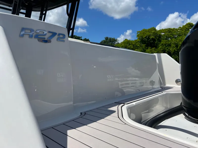 Slide: The Image of 2021 Robalo R272 Center Console boat deck under clear blue sky. - 47