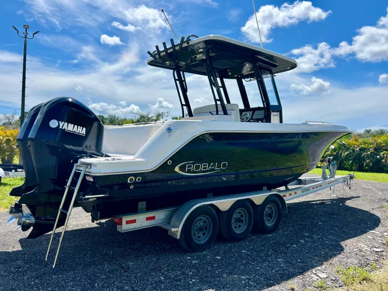 Slide: The Image of 2021 Robalo R272 Center Console boat on trailer, sunny day. - 49