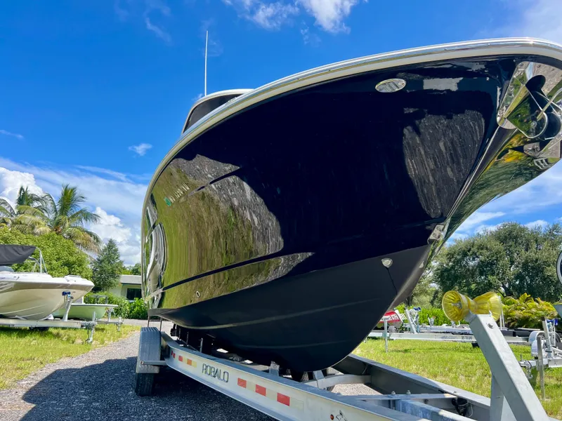 Slide: The Image of 2021 Robalo R272 Center Console boat on trailer, sunny day, blue sky. - 5