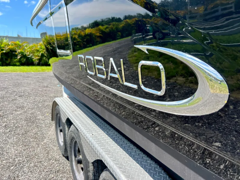 Slide: The Image of 2021 Robalo R272 Center Console boat on trailer, side view. - 7
