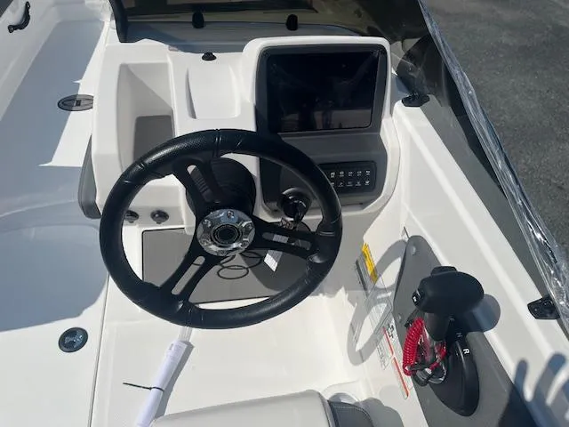 Slide: The Image of 2025 Tahoe T21 boat dashboard with steering wheel and control panel. - 9
