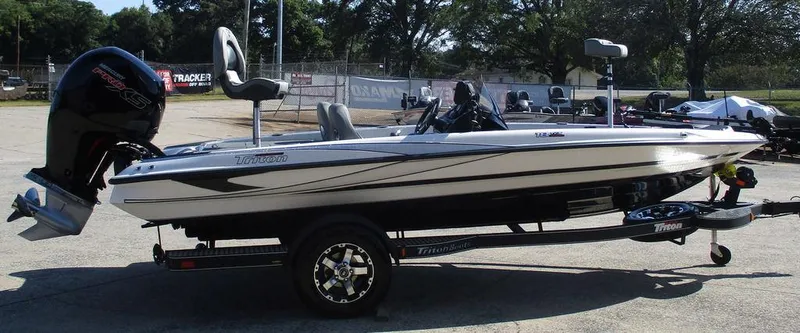 Slide: The Image of 2025 Triton 18 TrX boat on trailer, side view, outdoors. - 4
