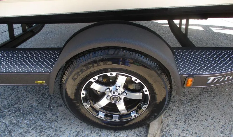 Slide: The Image of 2025 Triton 18 TrX trailer wheel with chrome rim and diamond plate fender. - 9