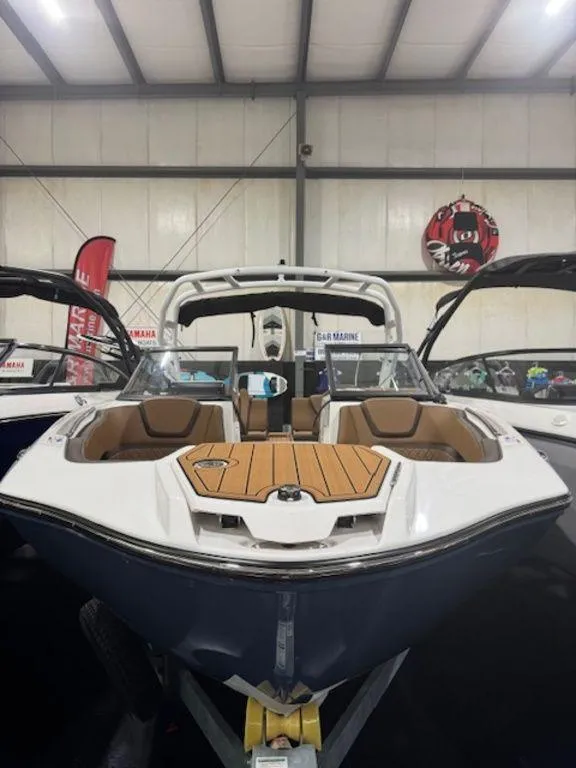 Slide: The Image of 2025 Yamaha Boats 252S in showroom, featuring sleek design and spacious seating. - 2