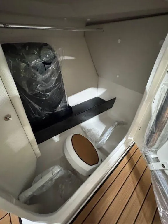 Slide: The Image of Interior of 2025 Yamaha Boats 252S, featuring a compact cabin with seating and storage. - 7