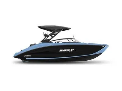 Slide: The Image of 2025 Yamaha Boats 255XD, sleek black and blue design, side view. - 1