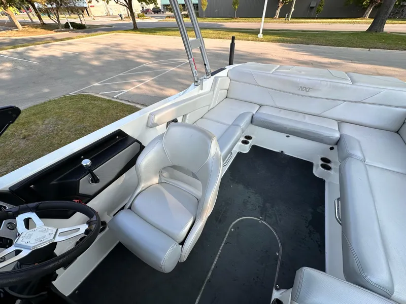 Slide: The Image of 2017 MasterCraft NXT22 boat interior with gray seating and steering wheel. - 16