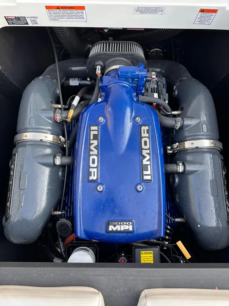 Slide: The Image of 2017 MasterCraft NXT22 Ilmor engine, blue cover, powerful performance. - 17