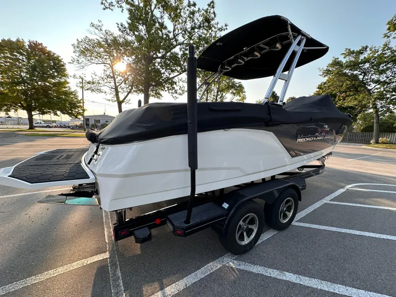 Slide: The Image of 2017 MasterCraft NXT22 boat on trailer, covered and parked outdoors. - 19