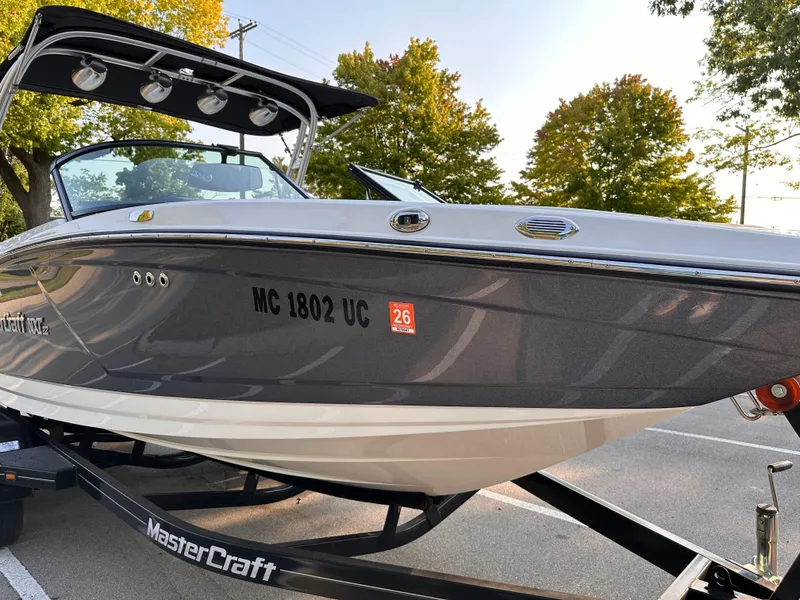 Slide: The Image of 2017 MasterCraft NXT22 boat on trailer, parked outdoors. - 20