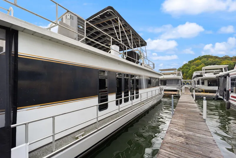 Slide: The Image of 2003 Monticello 18 X 70 River Yacht docked at marina under blue sky. - 11