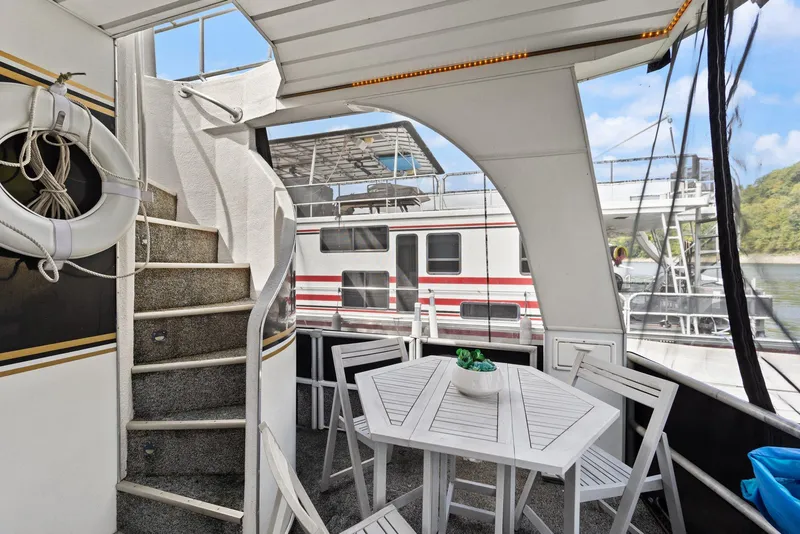 Slide: The Image of 2003 Monticello 18 X 70 River Yacht with outdoor seating and spiral staircase. - 12