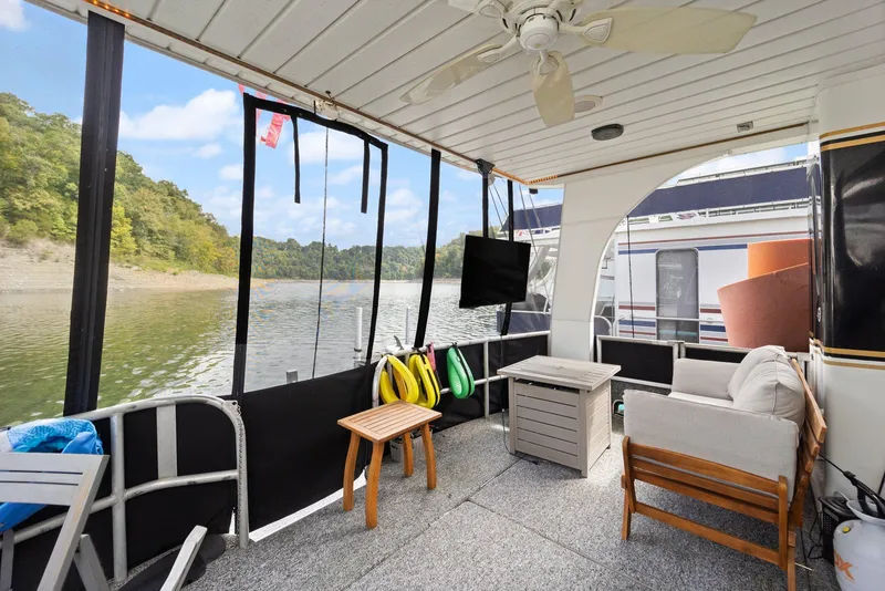 Slide: The Image of 2003 Monticello 18 X 70 River Yacht deck with seating, table, and scenic water view. - 13