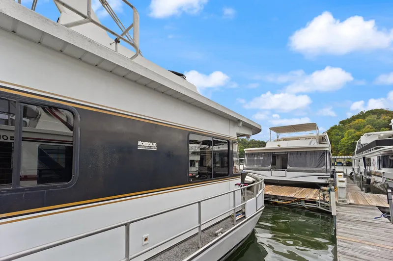 Slide: The Image of 2003 Monticello 18 X 70 River Yacht docked at marina under blue sky. - 16