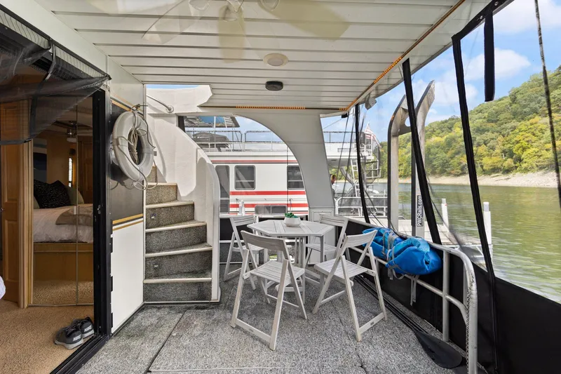 Slide: The Image of 2003 Monticello 18 X 70 River Yacht with outdoor seating and scenic river view. - 18