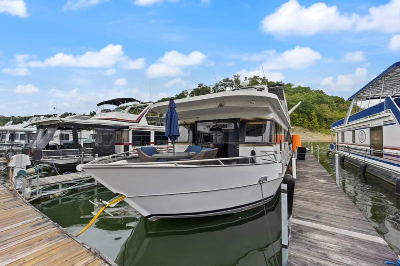 Slide: The Image of 2003 Monticello 18 X 70 River Yacht docked at marina under blue sky. - 2
